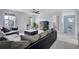 Open living room area with comfortable seating, large windows, a ceiling fan, and modern decor at 16747 E 97Th Pl, Commerce City, CO 80022