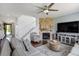 Spacious living room leading to entry and stairs with fireplace and plush seating arrangements at 16747 E 97Th Pl, Commerce City, CO 80022