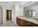 Bright main bathroom with double vanity, granite countertops, and a separate walk-in shower at 16747 E 97Th Pl, Commerce City, CO 80022