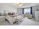 Inviting main bedroom featuring a plush bed, stylish seating, ceiling fan, and ample natural light at 16747 E 97Th Pl, Commerce City, CO 80022
