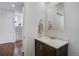 Stylish powder room featuring a modern vanity with white countertop and dark wood cabinet at 16747 E 97Th Pl, Commerce City, CO 80022