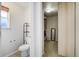 Well-lit toilet room with a walk-in closet, and neutral tones, offering a private and functional space at 16747 E 97Th Pl, Commerce City, CO 80022