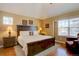 A spacious main bedroom features a tray ceiling, with large windows and plenty of natural light at 5604 E Nichols Pl, Centennial, CO 80112