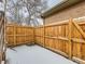 Small, fenced backyard with wooden deck and steps at 3256 N Clay St, Denver, CO 80211