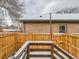 Small, fenced backyard with wooden deck and steps at 3256 N Clay St, Denver, CO 80211