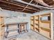 Unfinished basement with shelving, workbench, and laundry hookups at 3256 N Clay St, Denver, CO 80211