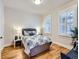 Bedroom with hardwood floors, window with shutters, and a bed at 3256 N Clay St, Denver, CO 80211