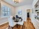 Dining room with glass table, white chairs, and built-in shelves at 3256 N Clay St, Denver, CO 80211