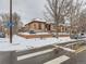 Front view of a brick home on a snow covered street at 3256 N Clay St, Denver, CO 80211