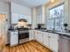 Kitchen with stainless steel appliances and hardwood floors at 3256 N Clay St, Denver, CO 80211