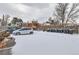 Snow covered parking area with dumpsters at 3256 N Clay St, Denver, CO 80211