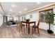 Finished basement features wood-look floors, a dining area, a seating area, and recessed lighting at 9983 Cottoncreek Dr, Highlands Ranch, CO 80130