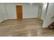 Partially finished basement with wood-look flooring and door to utility room at 9983 Cottoncreek Dr, Highlands Ranch, CO 80130