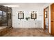 Bathroom features a double vanity, walk-in shower, neutral tiling, and plenty of natural light at 9983 Cottoncreek Dr, Highlands Ranch, CO 80130