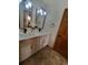 Dual sink bathroom with updated vanity, quartz countertops and stylish lighting fixtures at 9983 Cottoncreek Dr, Highlands Ranch, CO 80130