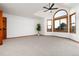 Bright bedroom boasts an arched window and modern ceiling fan providing ample natural light and comfortable airflow at 9983 Cottoncreek Dr, Highlands Ranch, CO 80130
