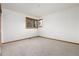 Minimalist bedroom with neutral carpet, two windows for natural light, and ample space at 9983 Cottoncreek Dr, Highlands Ranch, CO 80130