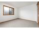 Simple bedroom with neutral carpet, a window for natural light, and a closet for storage at 9983 Cottoncreek Dr, Highlands Ranch, CO 80130