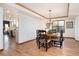 Dining room features hardwood floors, a round table with seating for four, and tray ceiling at 9983 Cottoncreek Dr, Highlands Ranch, CO 80130