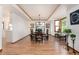 Inviting dining room with hardwood floors, elegant light fixture, and view of the backyard at 9983 Cottoncreek Dr, Highlands Ranch, CO 80130