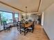 Spacious dining room with hardwood floors, tray ceiling, large window, and elegant chandelier at 9983 Cottoncreek Dr, Highlands Ranch, CO 80130