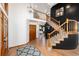 Grand foyer featuring hardwood floors, black accent wall and wood staircase at 9983 Cottoncreek Dr, Highlands Ranch, CO 80130