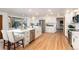 Open kitchen features an island with stainless steel appliances with hardwood floors and adjoins living room at 9983 Cottoncreek Dr, Highlands Ranch, CO 80130