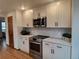 Close up of a kitchen with stainless steel appliances, quartz countertop and white herringbone backsplash at 9983 Cottoncreek Dr, Highlands Ranch, CO 80130