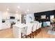 Spacious kitchen with white cabinets, a large island, stainless steel appliances, and wood floors at 9983 Cottoncreek Dr, Highlands Ranch, CO 80130