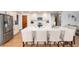 Beautiful kitchen with white cabinetry, stainless steel appliances, expansive island, and stylish seating at 9983 Cottoncreek Dr, Highlands Ranch, CO 80130