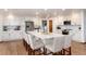 Bright kitchen with white cabinets, stainless steel appliances, and a large center island with seating at 9983 Cottoncreek Dr, Highlands Ranch, CO 80130