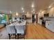 Bright open kitchen with stainless appliances, white cabinetry, large island with bar seating, and wood floors at 9983 Cottoncreek Dr, Highlands Ranch, CO 80130