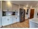 Stylish kitchen featuring white cabinetry, stainless steel appliances, and herringbone backsplash at 9983 Cottoncreek Dr, Highlands Ranch, CO 80130
