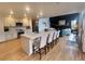 Modern kitchen with a large island, white countertops, updated appliances, and view into the living room at 9983 Cottoncreek Dr, Highlands Ranch, CO 80130