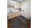 Well-lit laundry room with modern fixtures, quartz countertops, and slate floors at 9983 Cottoncreek Dr, Highlands Ranch, CO 80130