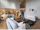 Bright, open living room with hardwood floors, neutral decor, and seamless flow to kitchen at 9983 Cottoncreek Dr, Highlands Ranch, CO 80130
