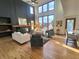 Bright, open living room with high ceilings, a fireplace and a wall of windows at 9983 Cottoncreek Dr, Highlands Ranch, CO 80130