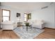 Bright living room with hardwood floors, neutral furniture, and charming decor creates a cozy atmosphere at 9983 Cottoncreek Dr, Highlands Ranch, CO 80130