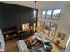Open concept living room with a striking fireplace, large windows, and neutral décor at 9983 Cottoncreek Dr, Highlands Ranch, CO 80130