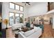 Open floor plan with a living room with hardwood floors, fireplace and view into kitchen area at 9983 Cottoncreek Dr, Highlands Ranch, CO 80130