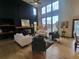Modern living room featuring high ceilings, large windows, hardwood floors, and lots of natural light at 9983 Cottoncreek Dr, Highlands Ranch, CO 80130