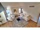 Bright living room with hardwood floors, comfortable seating and natural light from windows at 9983 Cottoncreek Dr, Highlands Ranch, CO 80130