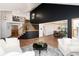 Spacious living room showcasing dark accent wall, modern chandelier, and open layout to dining area at 9983 Cottoncreek Dr, Highlands Ranch, CO 80130