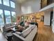 Bright, open living room featuring hardwood floors, many windows, and a view into the kitchen at 9983 Cottoncreek Dr, Highlands Ranch, CO 80130