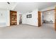 Spacious living room features built-in shelving and neutral carpeting, creating an inviting and functional living space at 9983 Cottoncreek Dr, Highlands Ranch, CO 80130