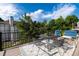 Outdoor patio features a metal table and seating, perfect for enjoying the lush landscaping and fresh air at 9983 Cottoncreek Dr, Highlands Ranch, CO 80130