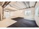 Spacious unfinished basement with visible ceiling beams, plastic vapor barrier, and natural light at 860 Goldenrod Pkwy, Henderson, CO 80640