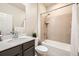 Bright bathroom featuring a shower-tub combo with modern fixtures and a single sink vanity at 860 Goldenrod Pkwy, Henderson, CO 80640