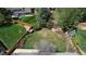 Aerial view showcasing the large fenced yard with garden beds, mature trees, and landscaping at 6062 S Emporia Cir, Englewood, CO 80111