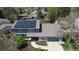 Aerial view of a charming two-story home featuring solar panels, a well-manicured yard, and a quaint neighborhood setting at 6062 S Emporia Cir, Englewood, CO 80111